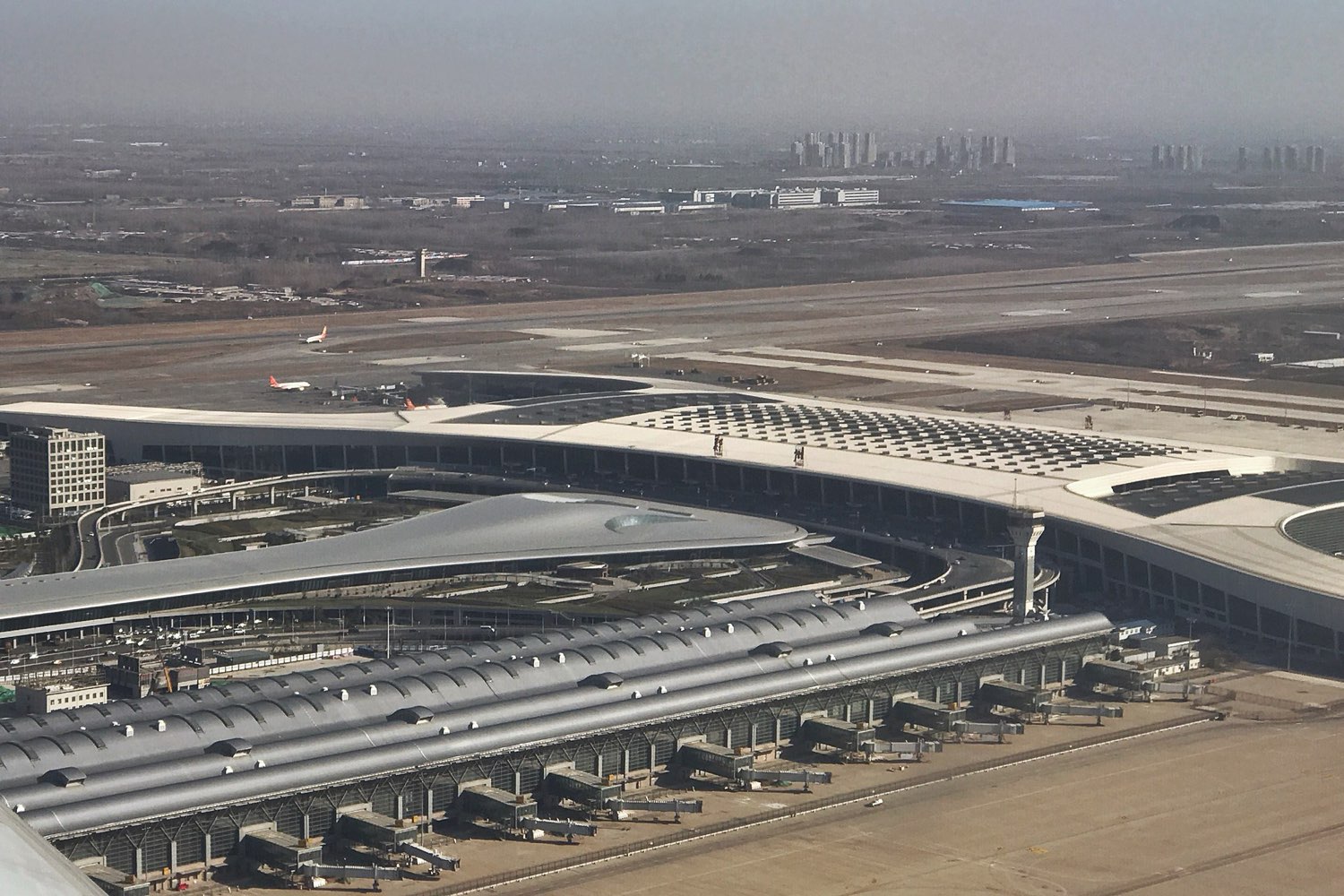 Aerial view of an international airport terminal and runway