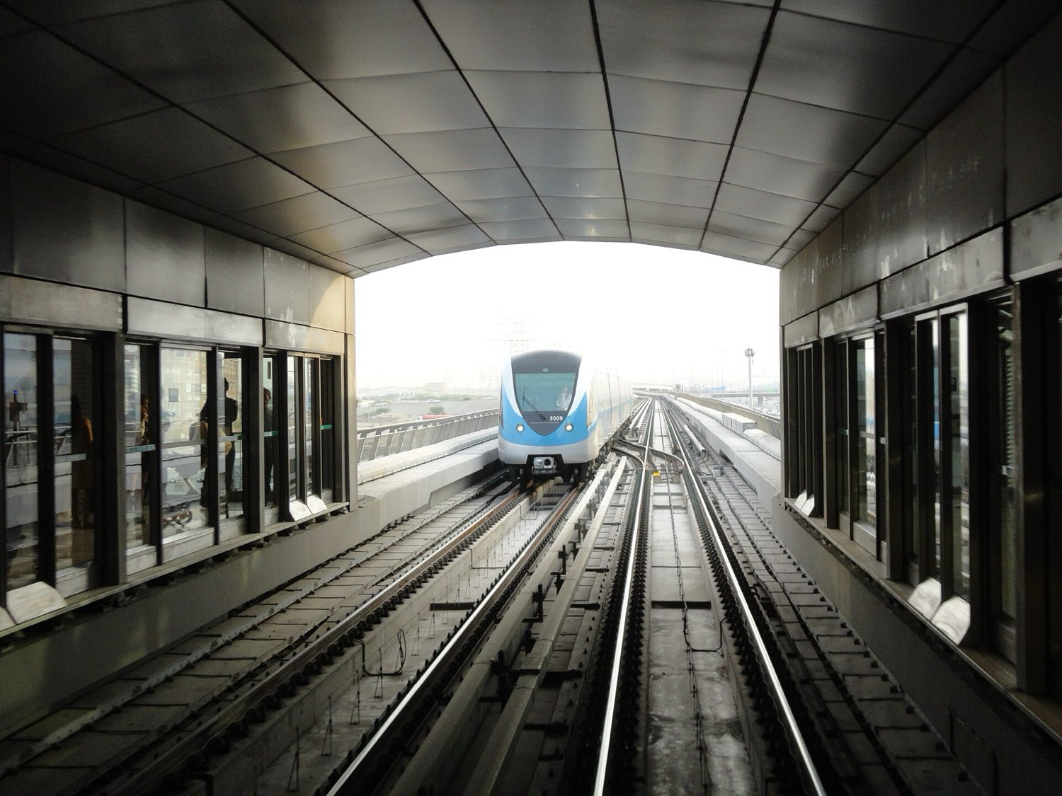 Driverless metro train arriving at an elevated station